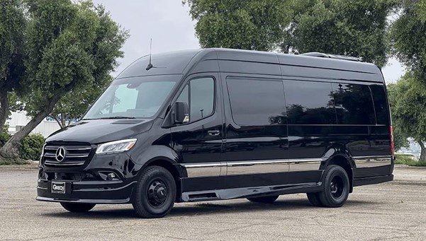 A Mercedes-Benz Sprinter parked in a parking lot, showcasing its sleek design and spacious cargo area.